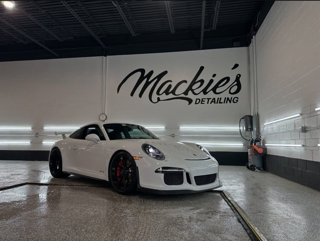 White Porsche GT3 inside Mackie’s Detailing studio, showcasing a freshly detailed exterior with enhanced gloss under professional LED lighting and a clean, polished finish.